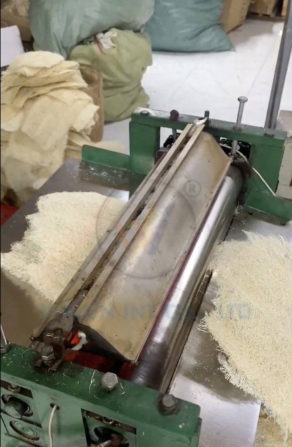 Natural loofah being compressed for export shipment