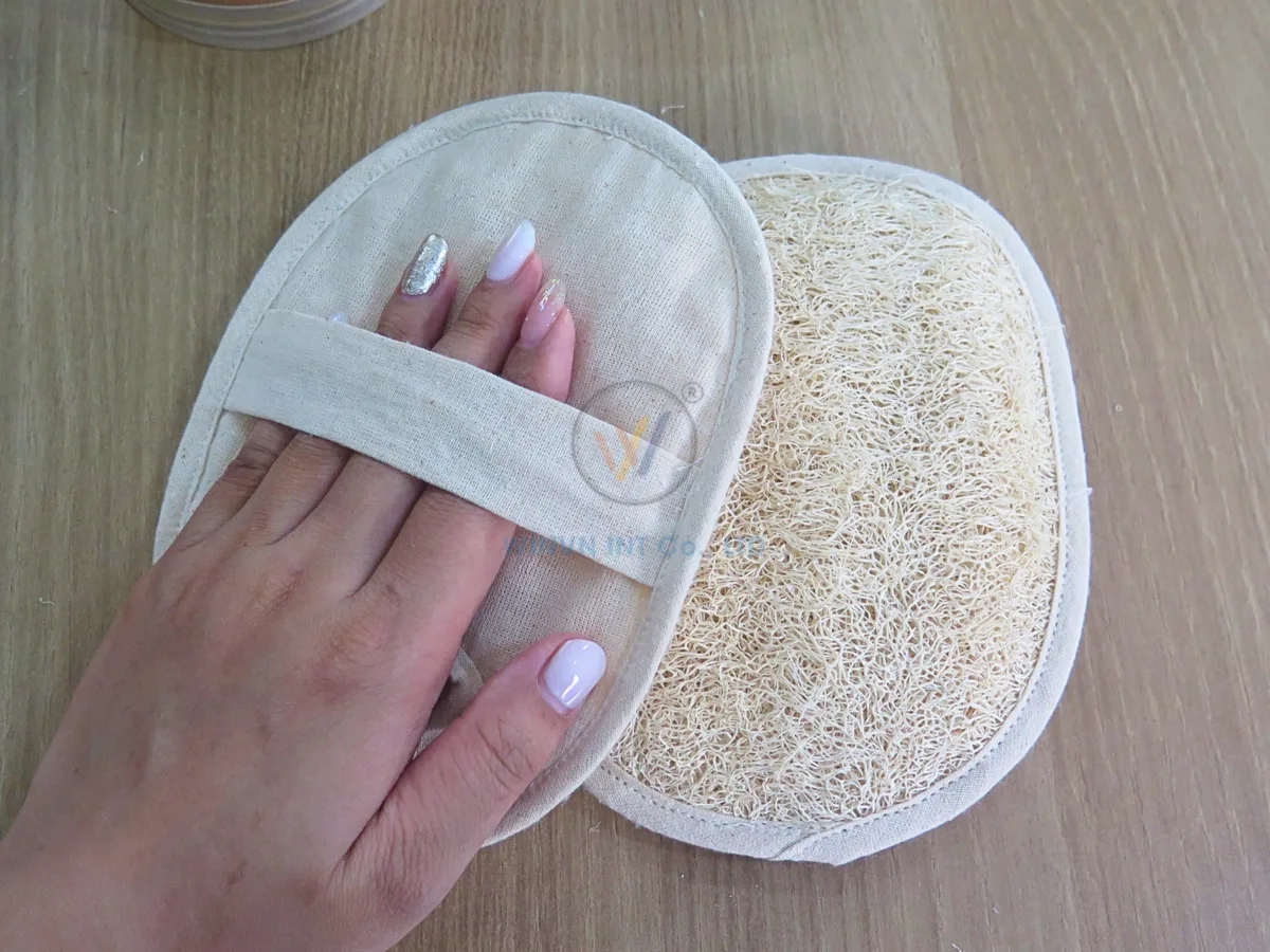 Natural loofah bath pad with jute fabric back and hand strap, stitched with cotton thread