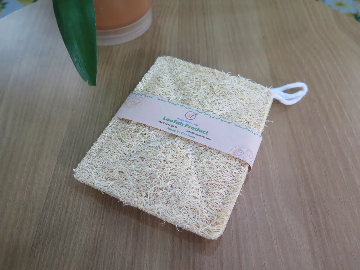 Natural loofah kitchen sponge with kraft belly band and hanging loop